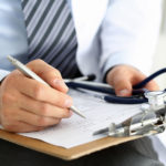 Male medicine doctor hand holding silver pen writing