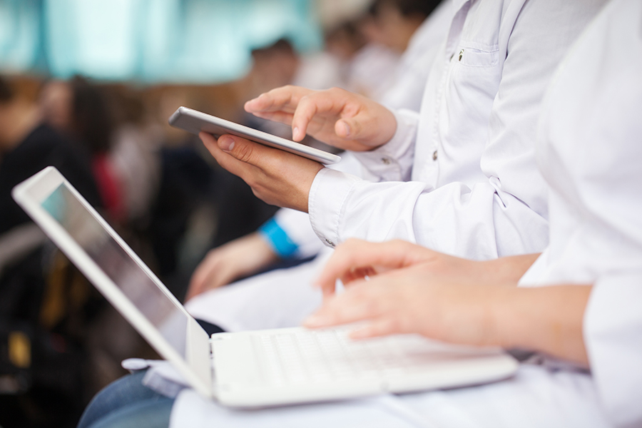 medical students or doctors using digital tablet and laptop