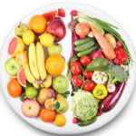 Fruits and vegetables are on opposite sides of the plate. Iimage on white background.