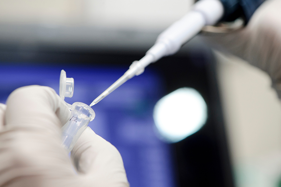 A researcher uses a micropipette to dispense a cell sample and analyze minute amounts of DNA in a science lab at the Influenza Research Institute at the University of Wisconsin-Madison on Sept. 2, 2011. The facility is led by Yoshi Kawaoka, professor of pathobiological sciences in the School of Veterinary Medicine, one of the world's premier virologists and researchers of influenza viruses. (Photo by Jeff Miller/UW-Madison)