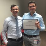 Dr. Andrew Baschnagel, DHO assistant professor, receives ARRO Educator of the Year award from Dr. Stephen Rosenberg, DHO chief radiation oncology resident.
