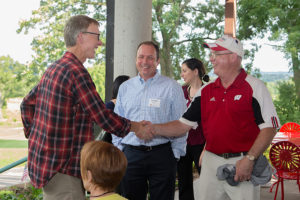 Neil O'Connor, retired UW Radiation Oncology social worker, greets Marshall Flax and Randy Eggert.