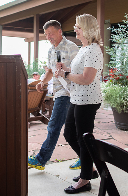 Dr. Greg Hartig and Teal Banbridge walk to the podium at 2021 Heads Up! Golf Outing