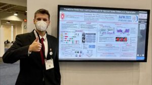 Image of Nicholas by his AAPM poster