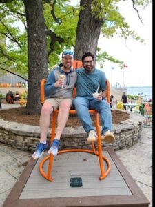 Two people on an oversized Memorial Union Chair