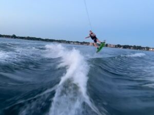 Water skier on mono borad mid-jump