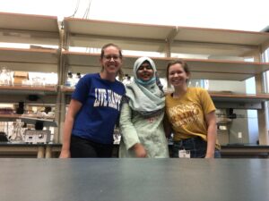 Picture of Dr. Cosper and two lab members in a fairly empty lab