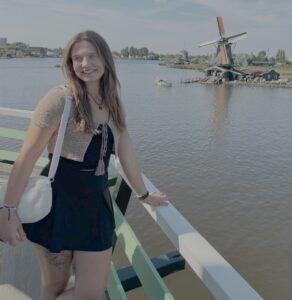 Photo of Niki Messick with windmill in the background.